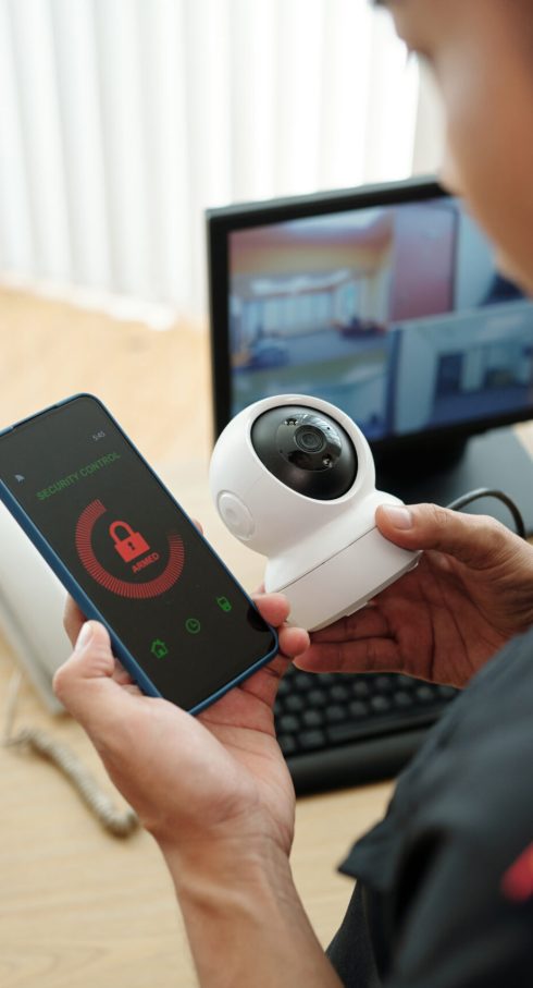 Security guard connecting surveillance camera to mobile application