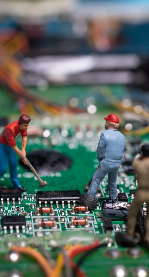 toy workers working on microchip, technology and development concept